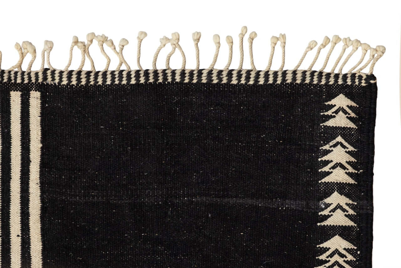 Char Noir – Black & Ivory Moroccan Rug featuring handwoven black and ivory geometric patterns.