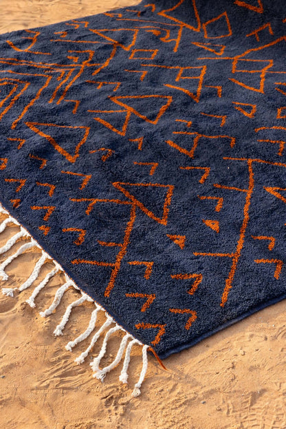 Amara Nuit - The mystique of Moroccan night, handwoven navy rug with terracotta motifs.