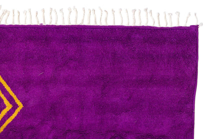 Sahara Gaze – Moroccan Rug with Golden Motifs, showcasing deep magenta and golden symbols.