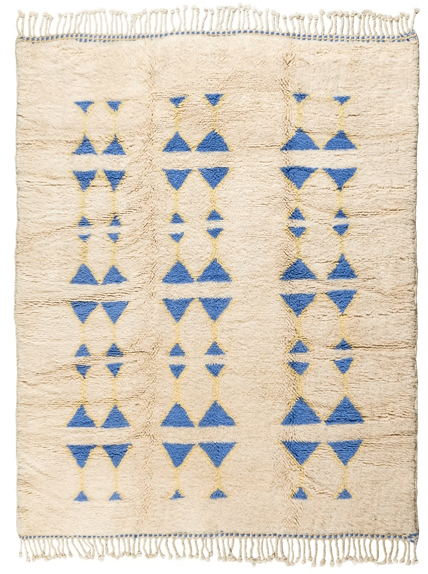 The Symbols by Fatima Rug – A Masterpiece of Craftsmanship featuring blue Amazigh symbols on a neutral base.