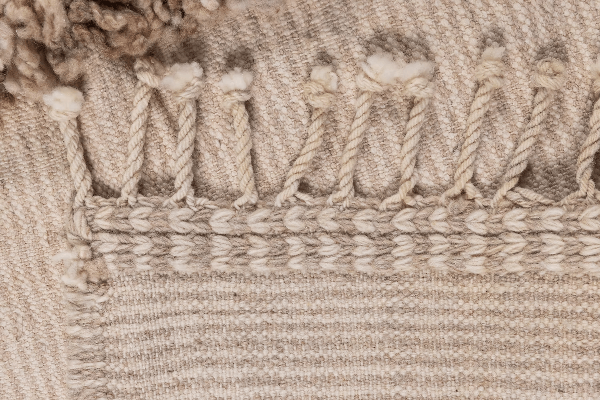 Close-up of the texture and detail of the Woven For Him rug by Moe Khadra, showcasing its handwoven craftsmanship.