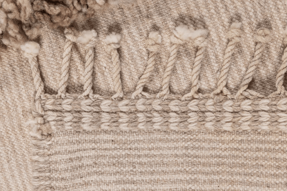 Close-up of the texture and detail of the Woven For Him rug by Moe Khadra, showcasing its handwoven craftsmanship.