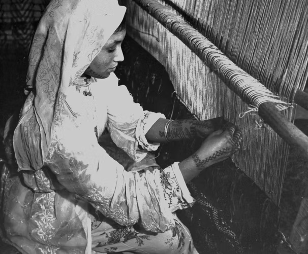 Woman weaving at a loom