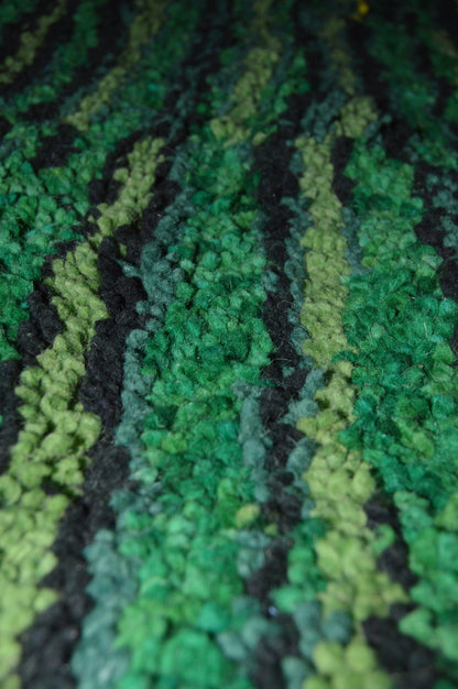 Close-up of a textured green and black fabric surface