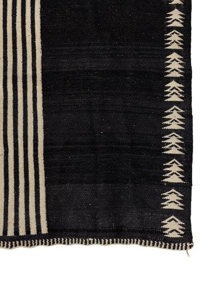 Char Noir – Black & Ivory Moroccan Rug featuring black field with ivory geometric patterns and linear borders.