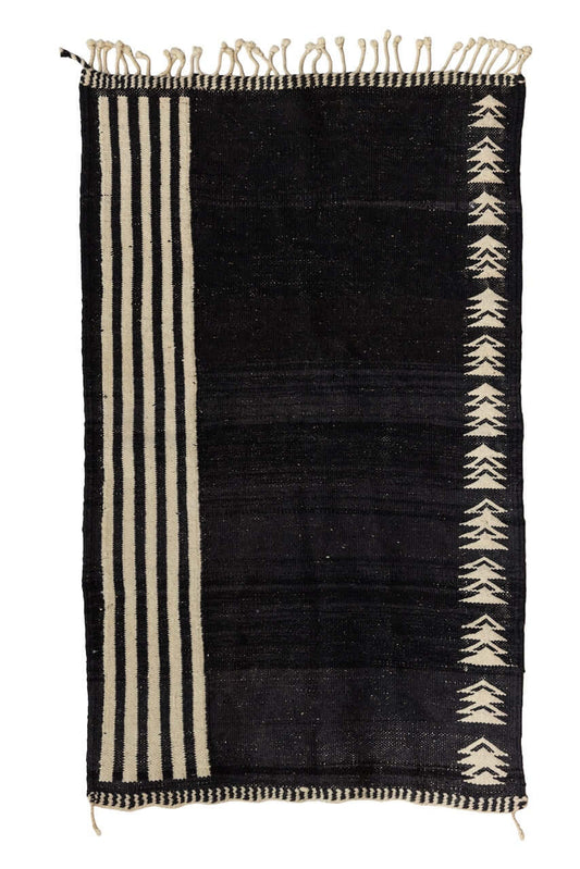 Char Noir – Black & Ivory Moroccan Rug showcasing a black field with ivory geometric patterns and linear borders.